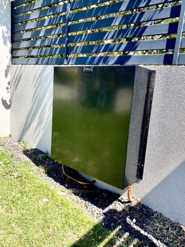 Dark brown home filtration system mounted on a fence