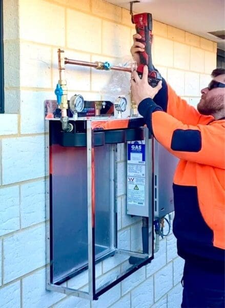 Home Filtration Stystem being installed by man in high-viz clothing